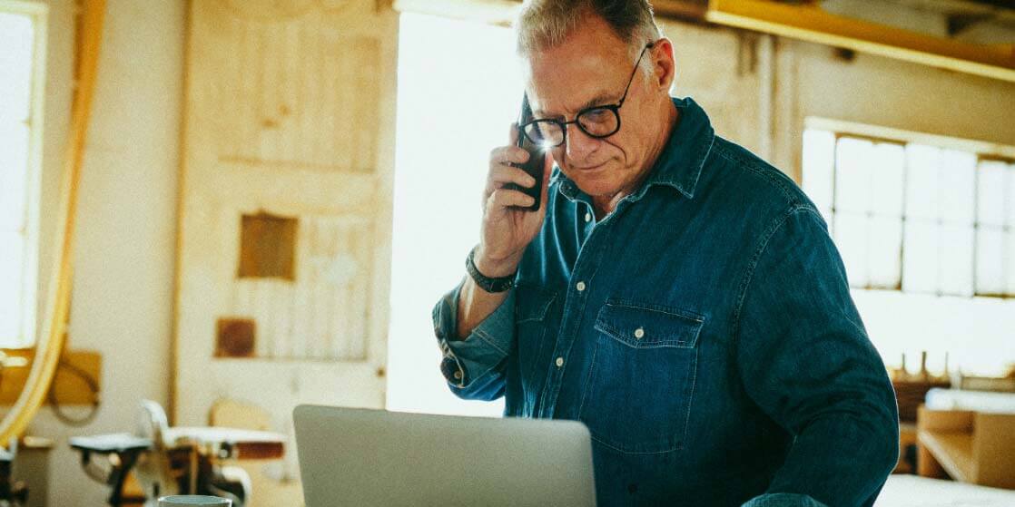 man in construction site using a laptop